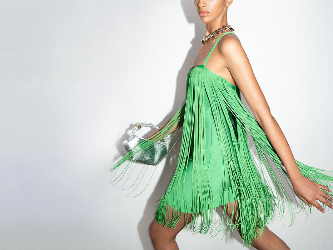 A short green occasion dress with fringes