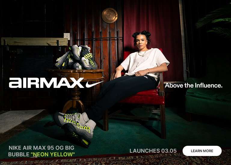 Promotional banner for the Nike Air Max 95 OG Big Bubble Neon Yellow featuring a woman in a white t-shirt and black joggers sitting in a red armchair. She is wearing the grey and neon yellow sneakers, with several more pairs stacked on a wooden side table. The image includes the Air Max logo, the slogan Above the Influence, and a launch date of 03.05.