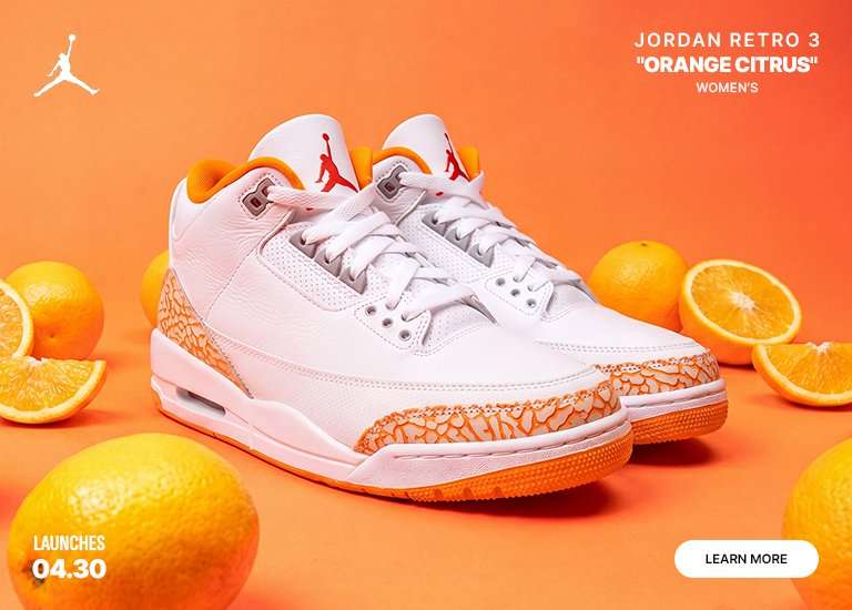 A pair of women's Jordan Retro 3 Orange Citrus sneakers featured against a vibrant orange background surrounded by fresh oranges and citrus slices. The shoes are primarily white with orange elephant print overlays and red Jumpman logos. Text indicates a 04.30 launch date.
