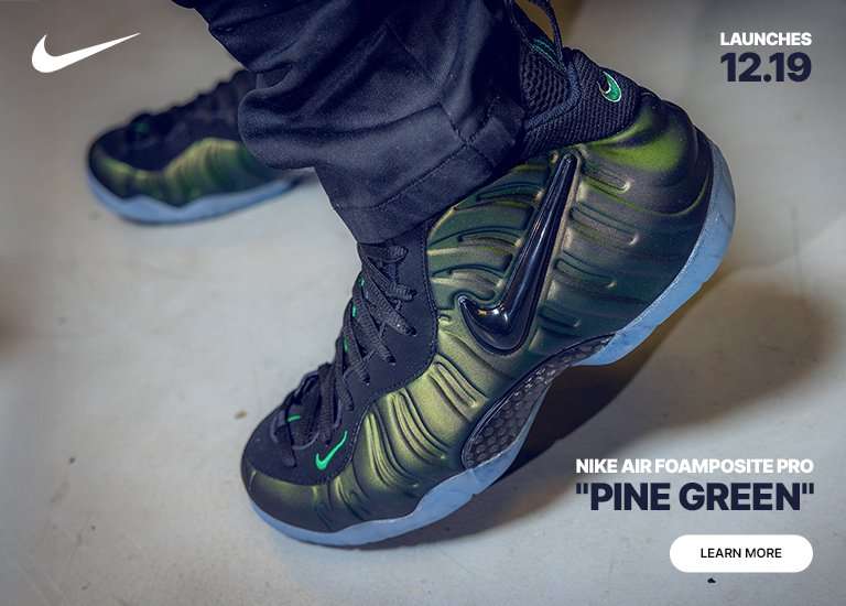 Nike Air Foamposite Pro Pine Green sneakers shown on-foot in a green locker room, with a close-up highlighting the molded upper and icy sole. Launches 12.19. Learn More.