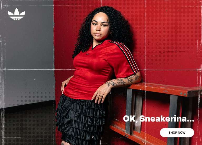 Adidas promotional banner featuring a woman with curly hair leaning against a red wall, wearing a red V-neck jersey and a tiered black ruffled skort. The left side showcases a close-up of red Adidas Samba Mary Jane sneakers with white stripes, paired with thick black crew socks. White text reads OK, Sneakerina… with a white Shop Now button in the bottom right corner. 