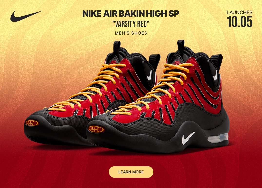 Nike Air Bakin High SP Varsity Red men's sneakers in red, black, and yellow displayed on a red-to-gold gradient background.