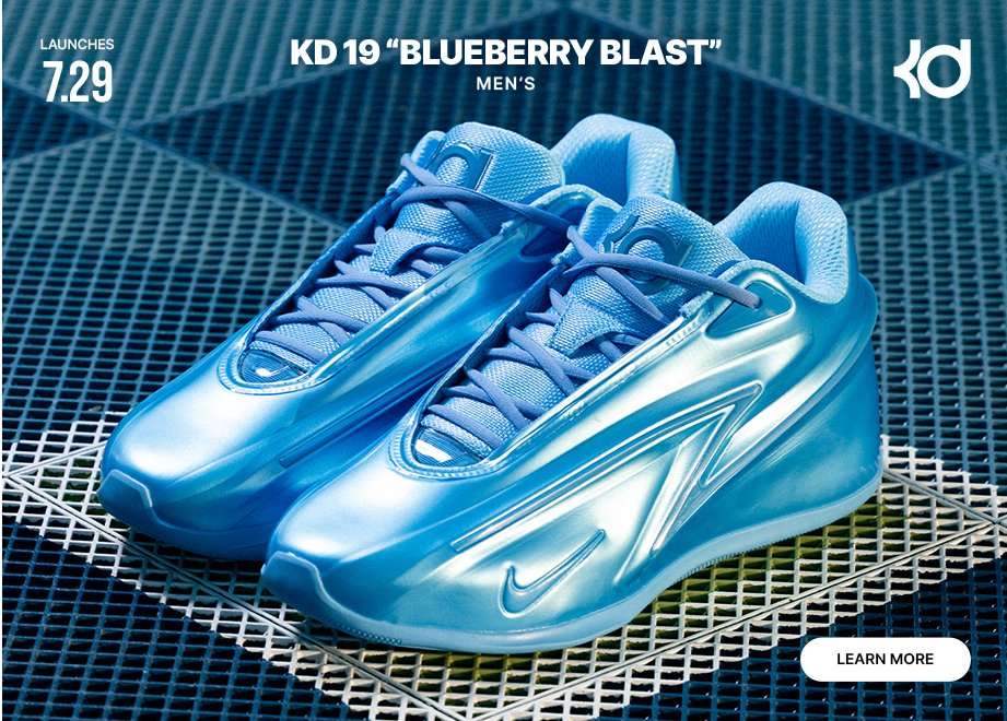 Nike KD 19 Blueberry Blast men's basketball shoes in a metallic blue colorway displayed on a blue geometric court surface. Graphic includes launch date of 7/29, KD branding, and a Learn More call-to-action.