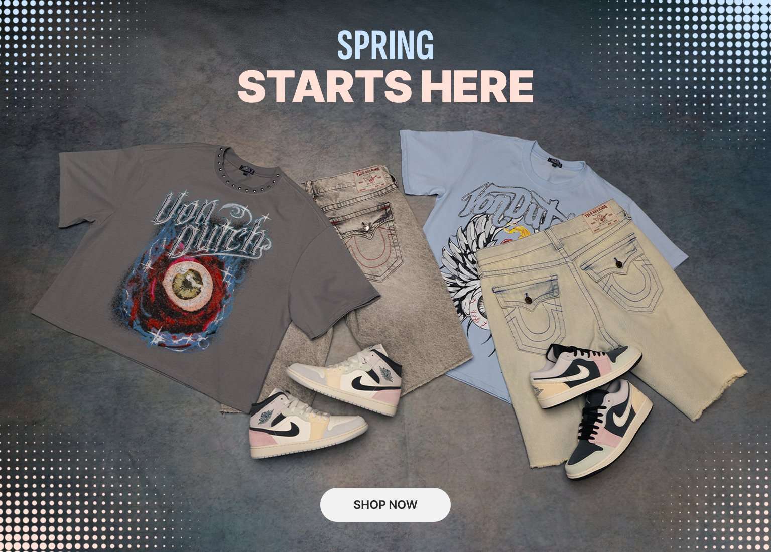 Promotional banner with the text SPRING STARTS HERE and a Shop Now button. The image features a flat lay of spring apparel, including Von Dutch graphic tees, True Religion denim shorts, and pastel-colored Nike Air Jordan 1 sneakers on a textured grey background.