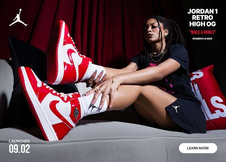 Promotional image for the Jordan 1 Retro High OG Nails & Grails in women's and kids' sizing, featuring red and white patent leather sneakers displayed in a studio setting with red drapery, lounge furniture, and close-up product styling. Text includes launch date 09.02 and Learn More button.