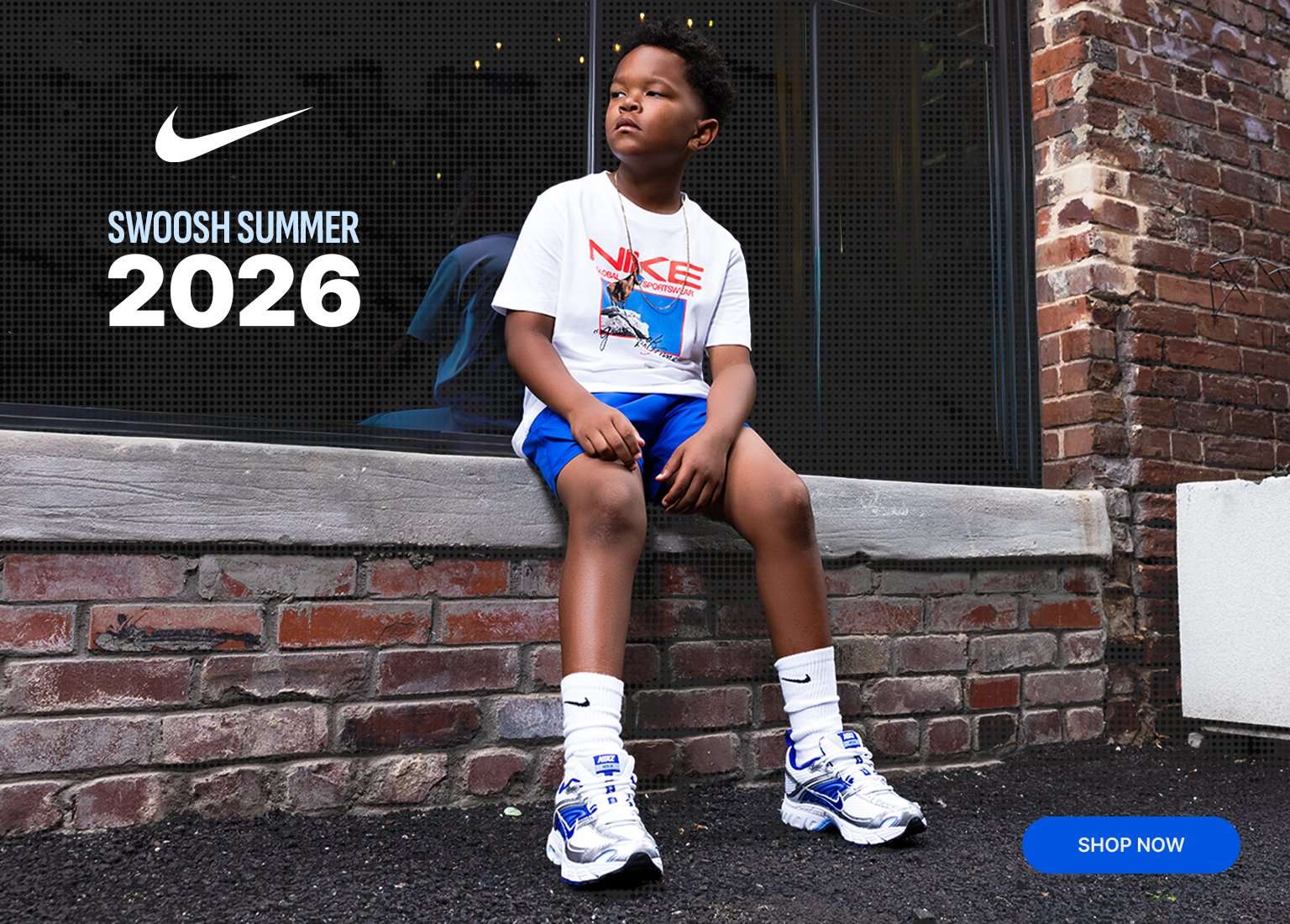 A multi-panel marketing banner featuring a close-up of blue, silver, and white Nike sneakers on the left, and a young boy sitting on a brick ledge wearing a Nike graphic t-shirt, blue shorts, and matching sneakers on the right. Text reads Swoosh Summer 2026 with a Nike swoosh logo on the left, and a blue Shop Now button is in the bottom right corner.