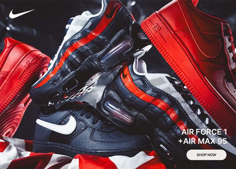 A stack of Nike sneakers featuring two pairs of Air Max 95s in black and white with a red stripe, an all-red Air Force 1, and a black Air Force 1 with a white Swoosh, resting on a red and white patterned fabric.