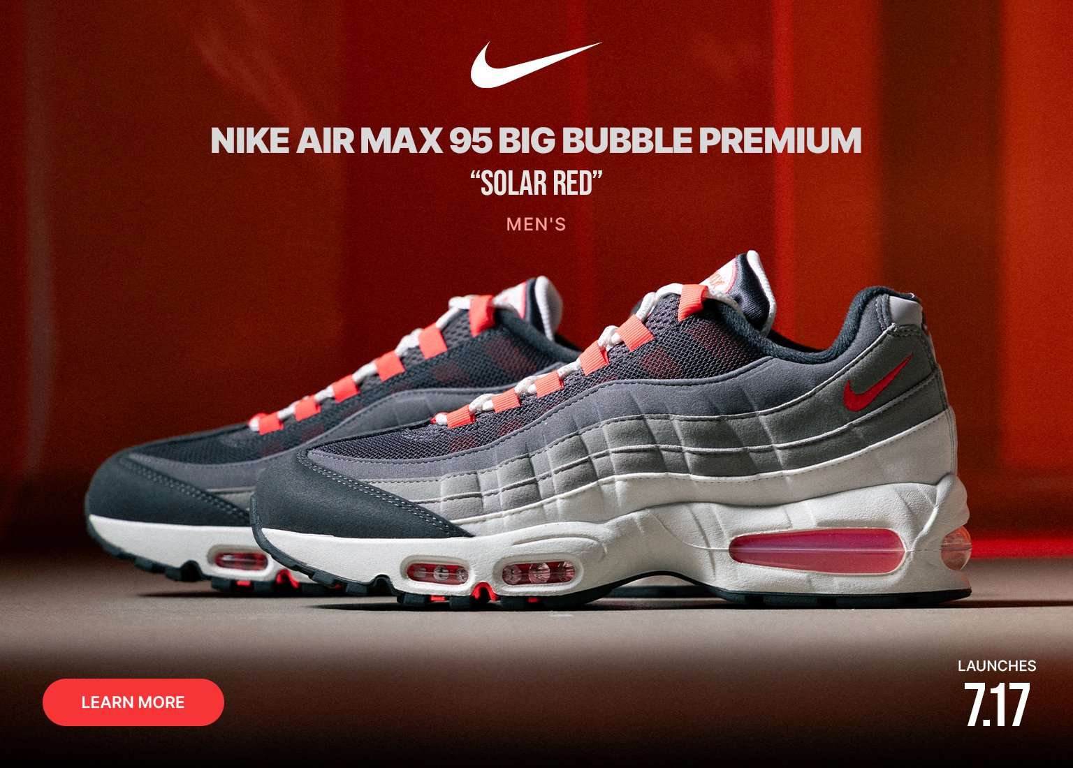 Close-up and profile views of the Nike Air Max 95 Big Bubble Premium Solar Red sneaker, featuring gray and black suede panels, red accents, white laces, and visible Air cushioning against a red backdrop.