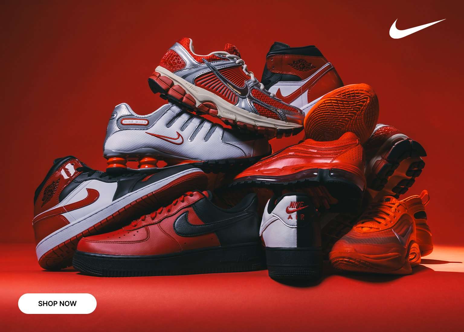 Stacked assortment of red and black Nike sneakers and basketball shoes displayed against a red background with Nike logo and Shop Now button.