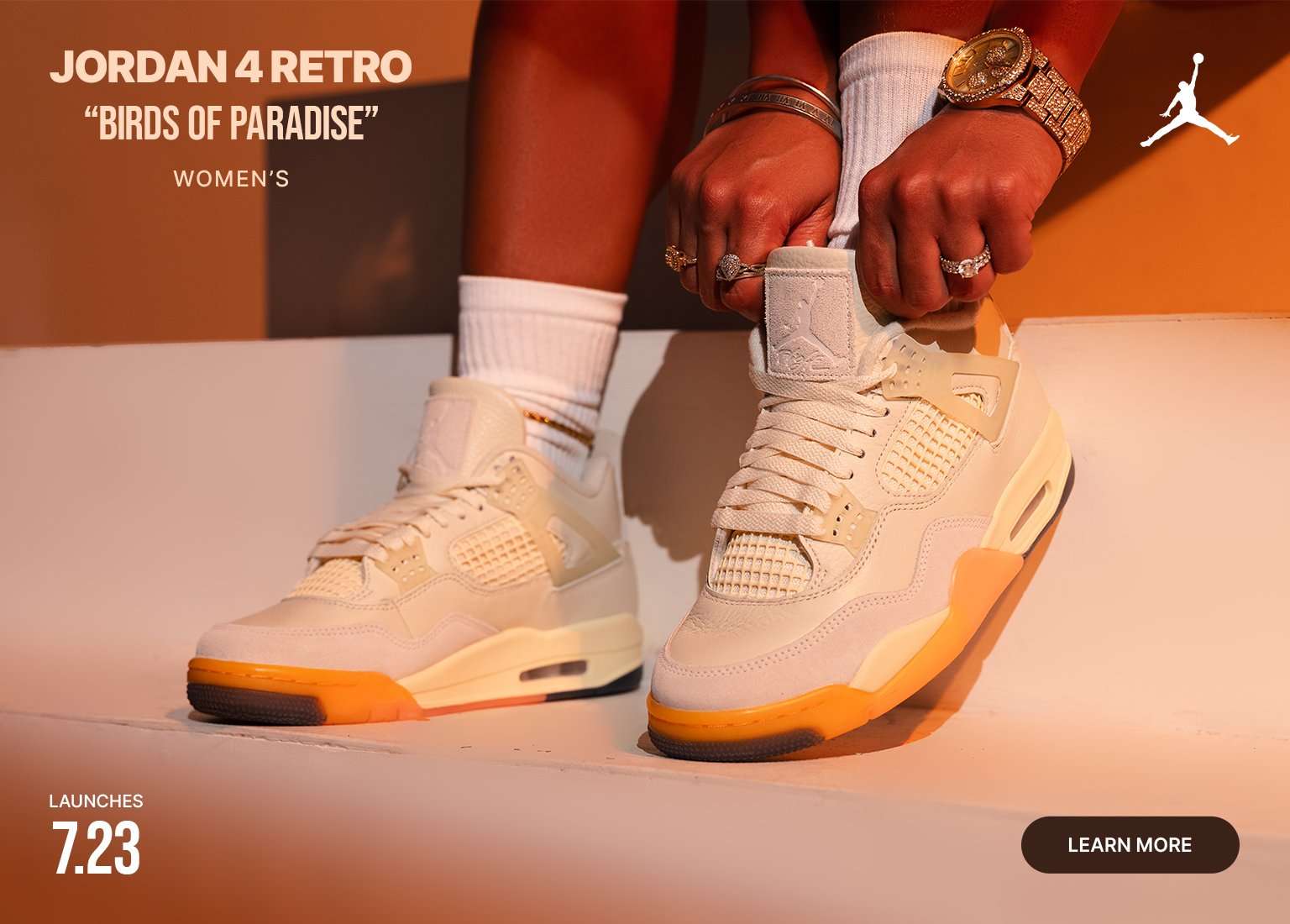 Women's Air Jordan 4 Retro Birds of Paradise sneakers in cream and orange tones with launch date promotion.