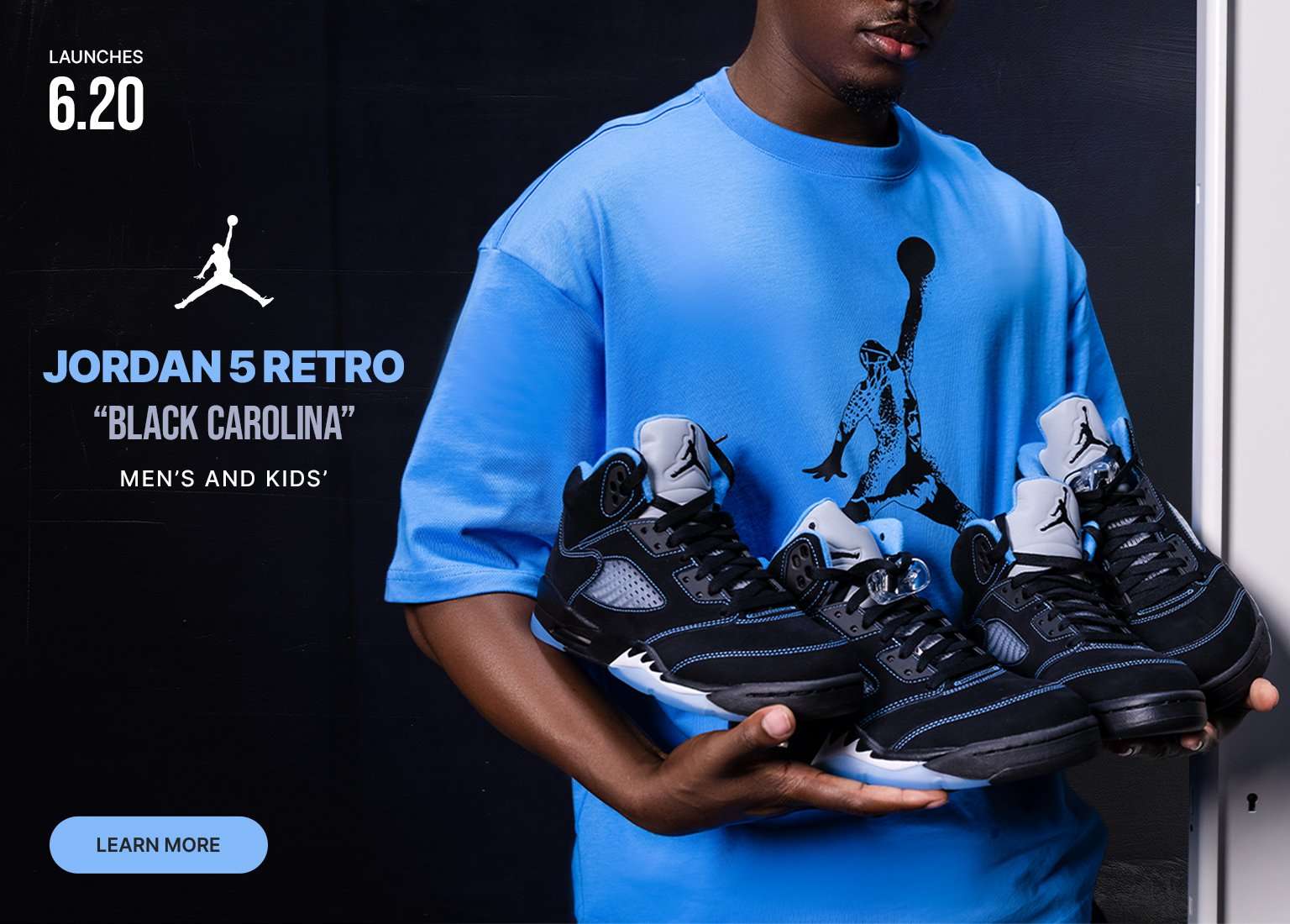 A split banner showing a man wearing a light blue Jordan t-shirt and matching shorts. On the right, he holds three pairs of black and blue Jordan 5 Retro sneakers. Text reads, Launches 6.20, Jordan 5 Retro Black Carolina, Men's and Kids', with a Learn More button.