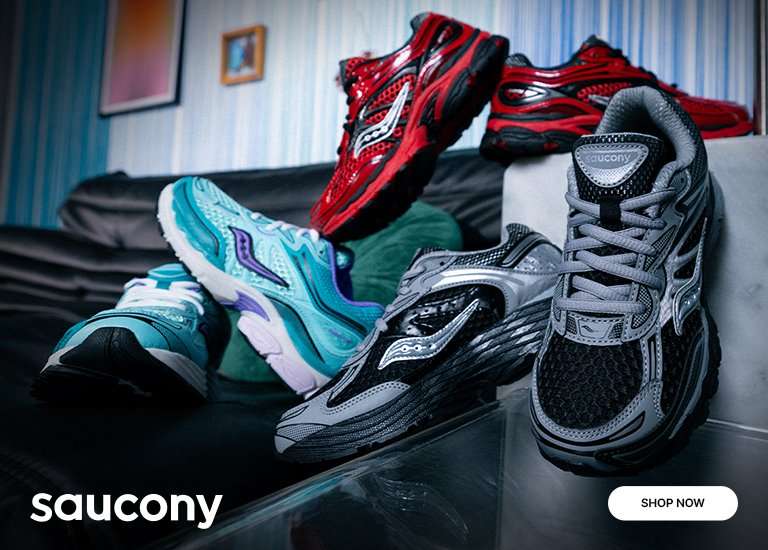 Saucony Omni 9 sneakers in black, gray, red and aqua colorways displayed on a leather sofa and table.