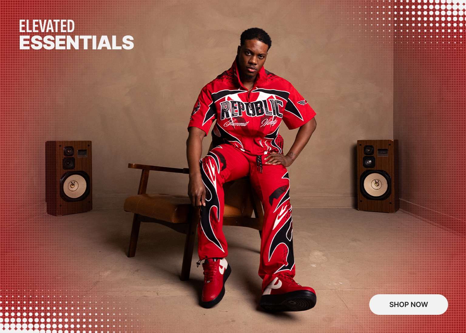 Lifestyle banner titled Elevated Essentials featuring a model in a red, black, and white Smoke Rise woven set. The outfit includes a short-sleeve zip-up shirt with Republic branding and matching graphic pants with a flame-style design. He is seated on a leather chair between two vintage speakers with a Shop Now button in the corner.