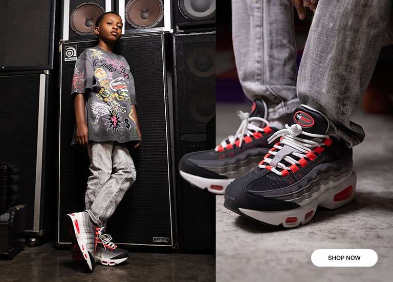 Kids wearing a graphic oversized tee, denim pants, and Nike Air Max 95 sneakers in front of stacked speakers.