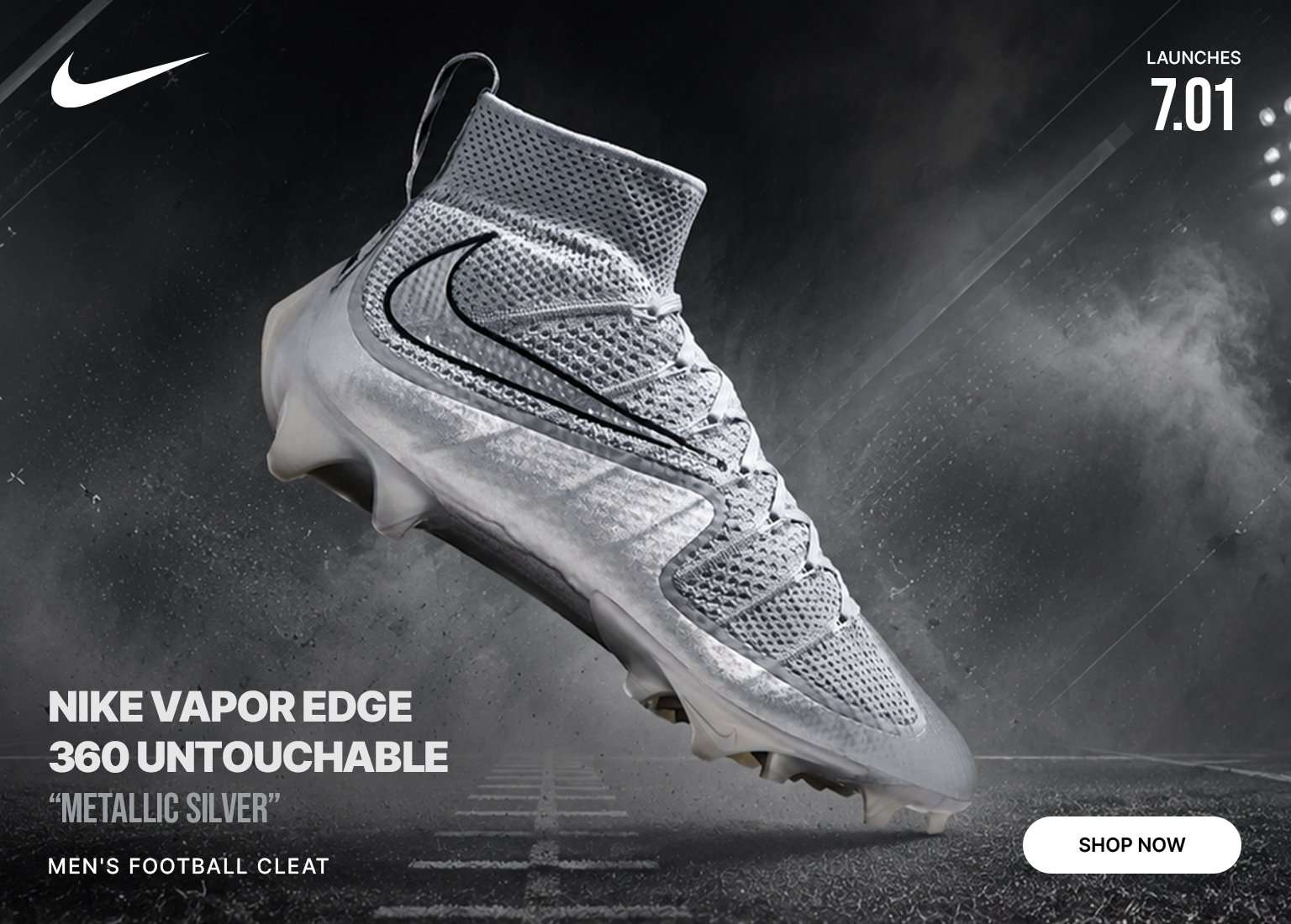 Nike Vapor Edge 360 Untouchable Metallic Silver men's football cleat on a stadium field under bright lights.