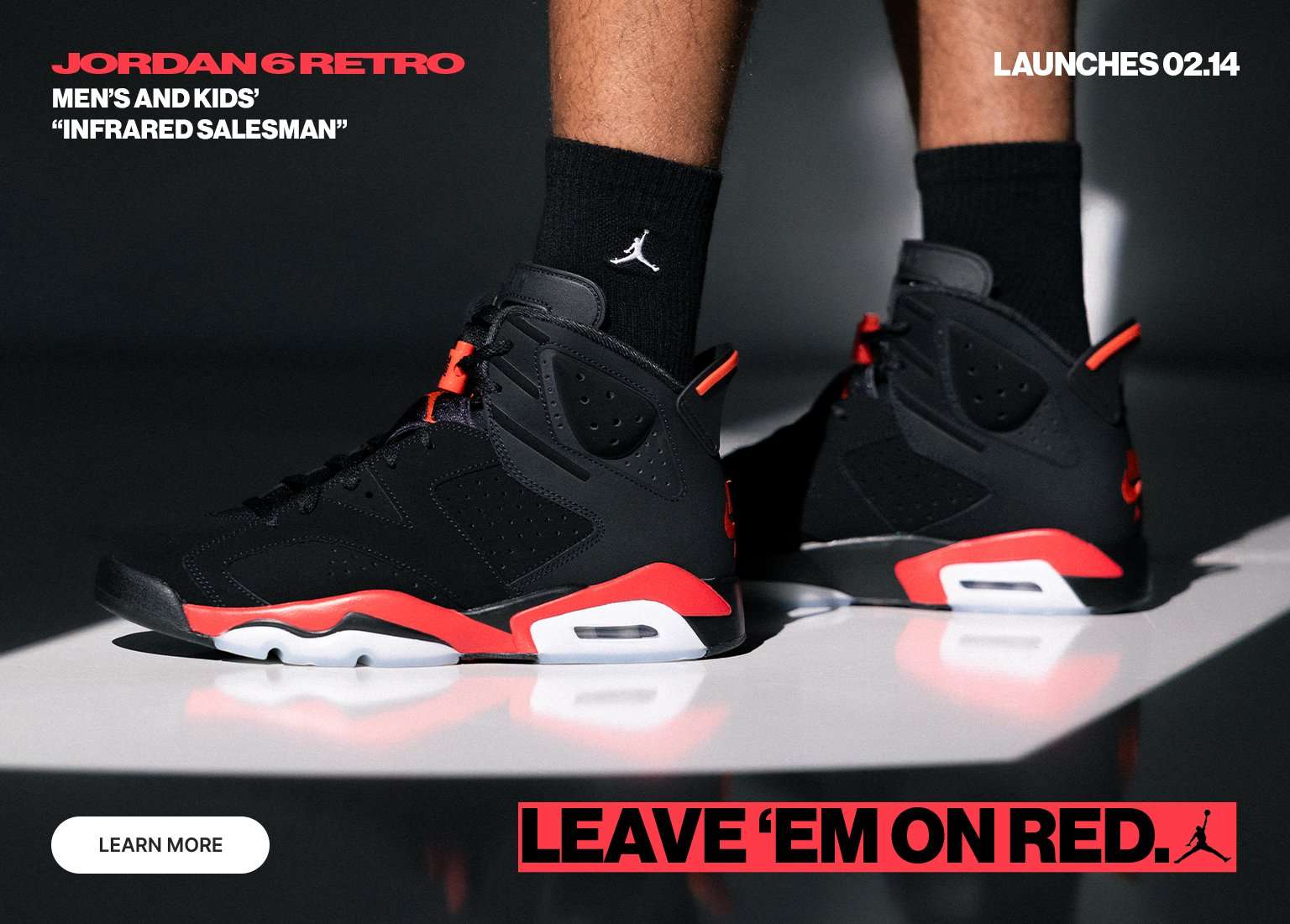 A promotional banner for the Jordan 6 Retro Infrared Salesman features three distinct views of the sneaker and coordinating apparel against a dark backdrop. The central image focuses on a model's feet wearing the black nubuck sneakers with vibrant Light Crimson accents, while side panels show a close-up of the factory-inspired hangtag and a full-body shot of the model in a matching graphic tracksuit.