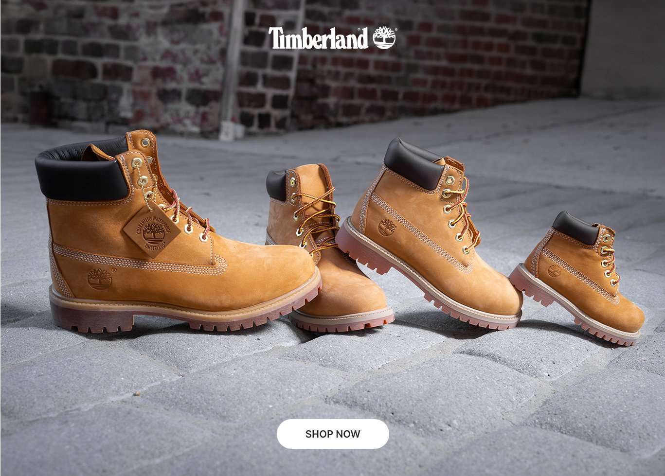 Timberland wheat boots in adult and kids sizes displayed on a stone floor.