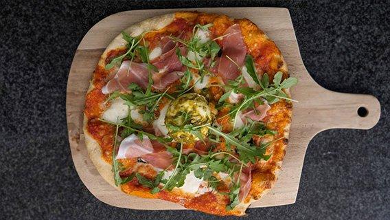 Sourdough pizza with Parma ham, burrata, mozzarella & pesto