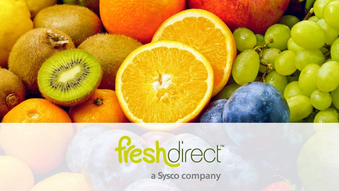 Assorted fresh fruits including oranges, kiwis, grapes, and plums with the FreshDirect logo at the bottom.