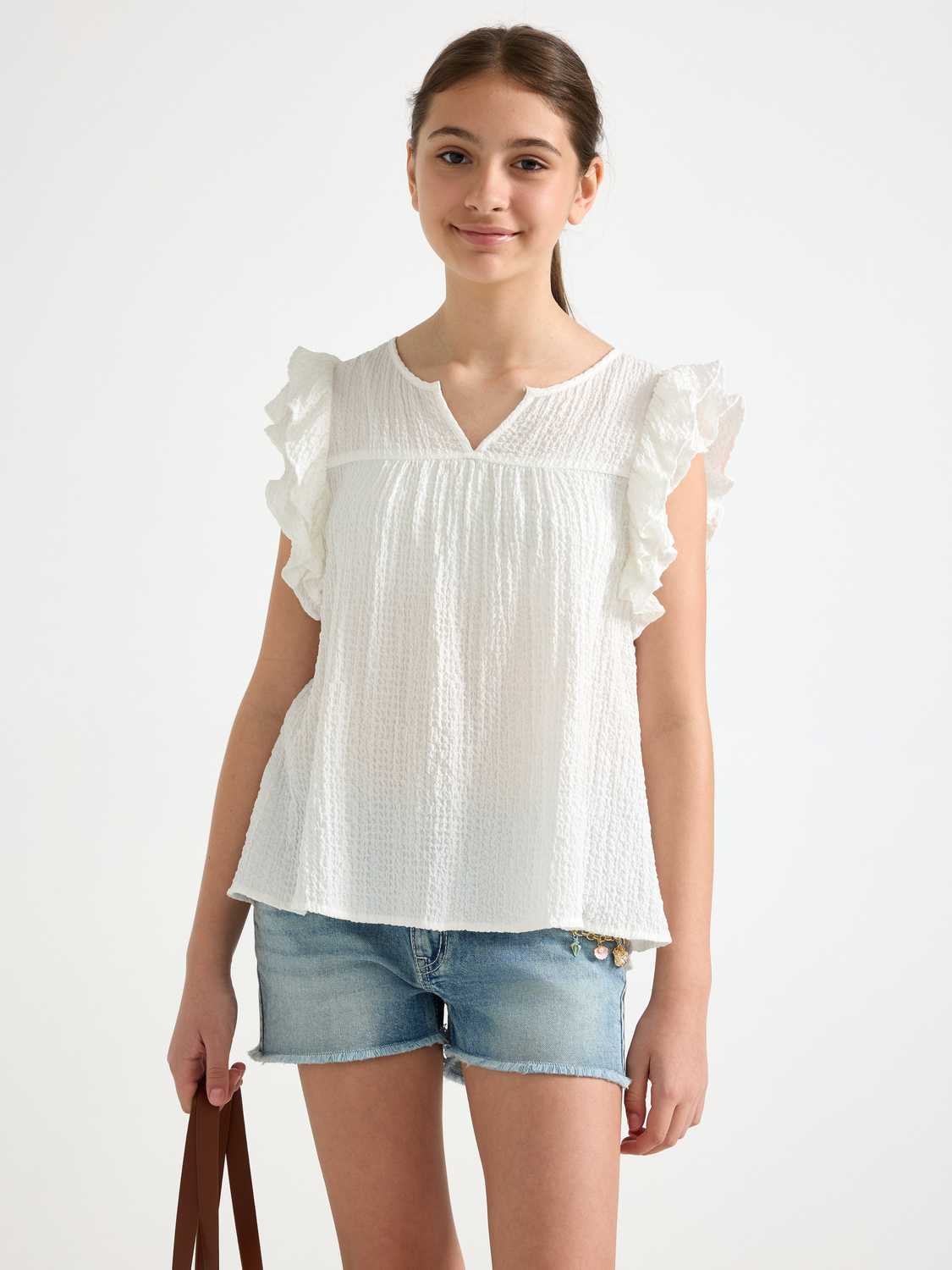 Ärmlös blus med volang
