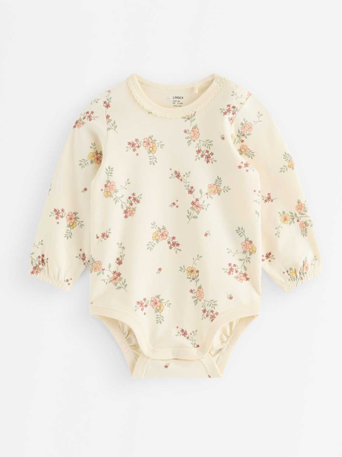 Långärmad body med blommor