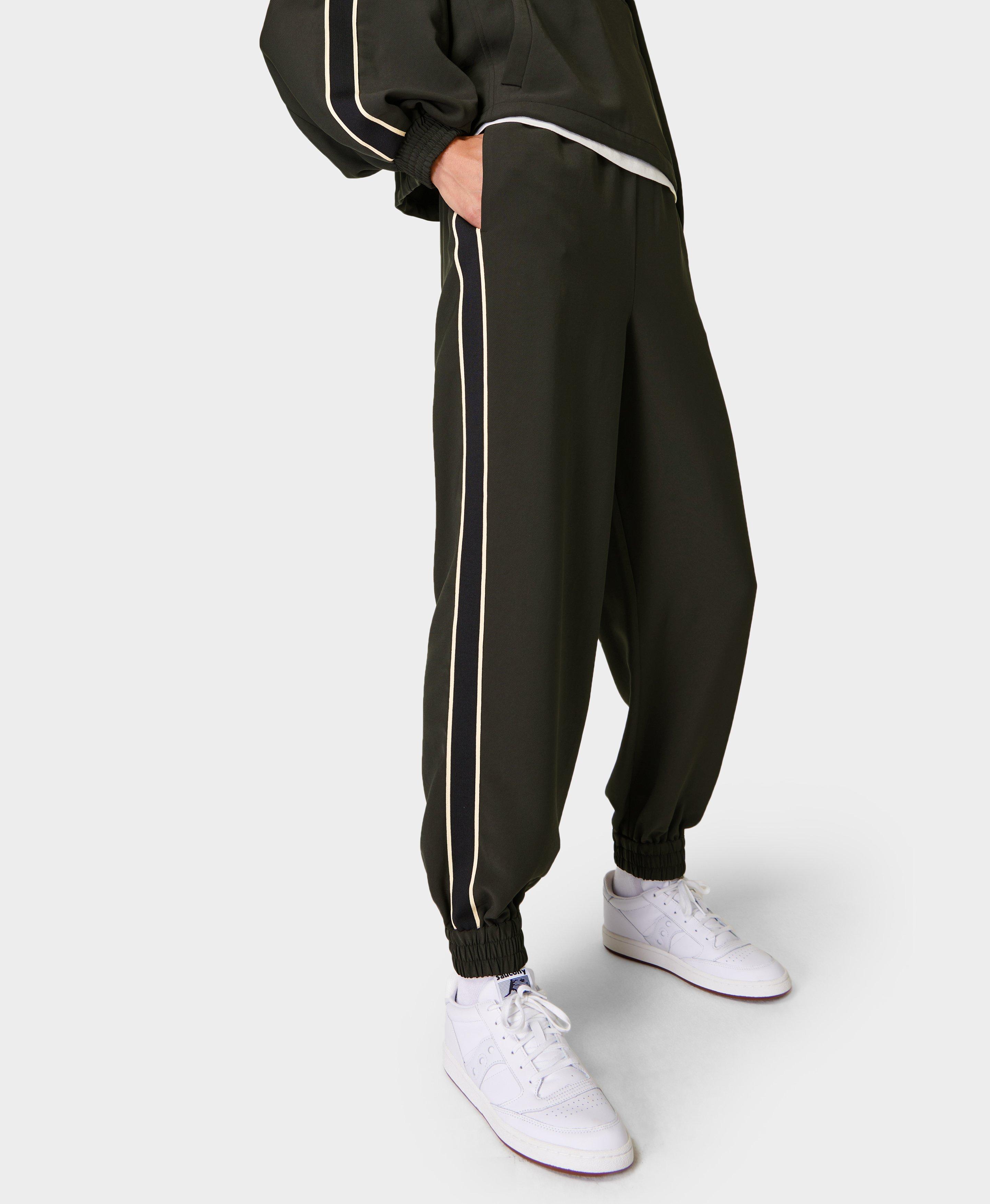 Black track pants with green sale stripe