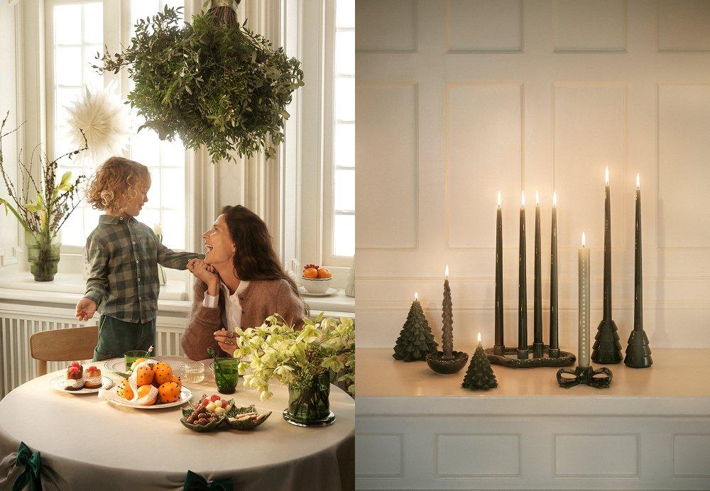 Person och barn vid ett juldukat bord samt ett arrangemang med tända mörka ljus och dekorativa granar.
