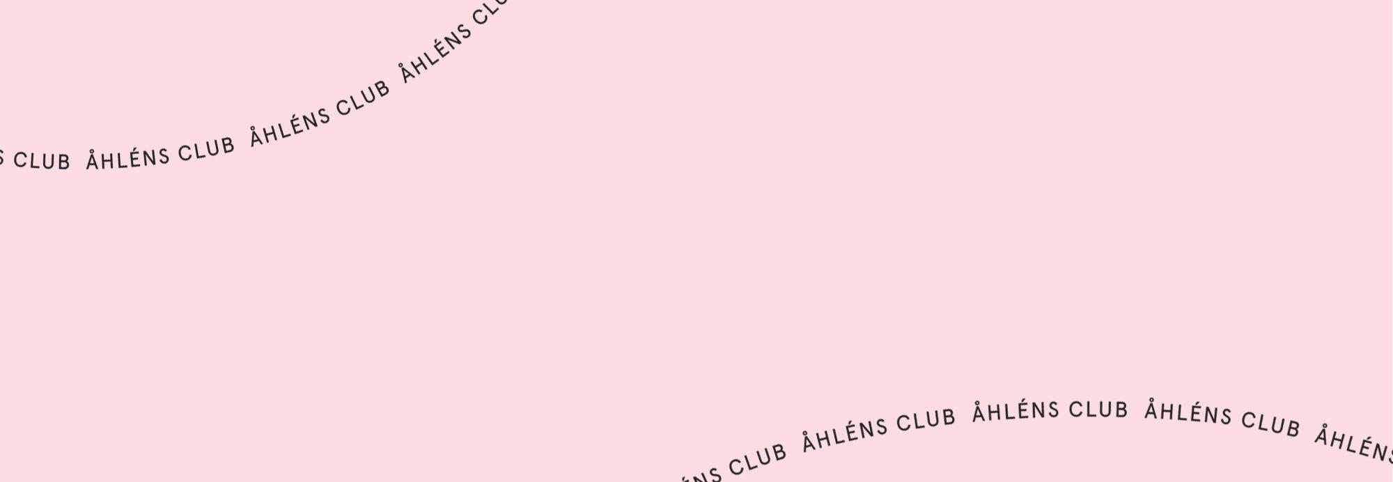 Rosa bakgrund med texten "Åhléns Club" i svart som går i en våg över bilden.