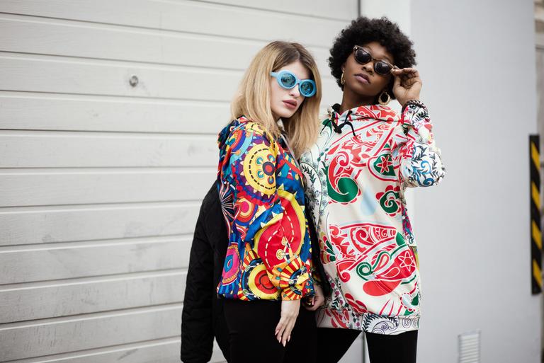 Two women wearing brightly colored clothing