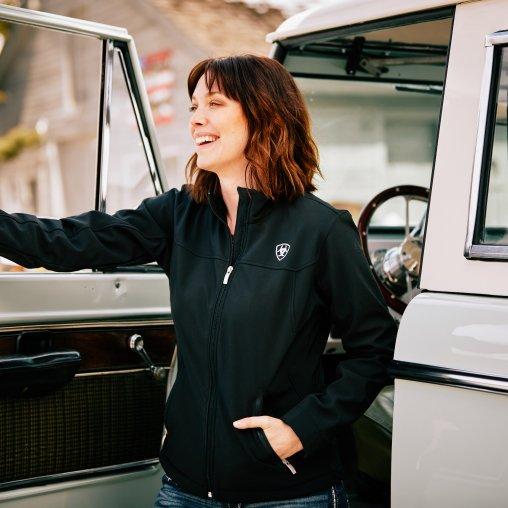woman standing in front of truck in ariat clothing