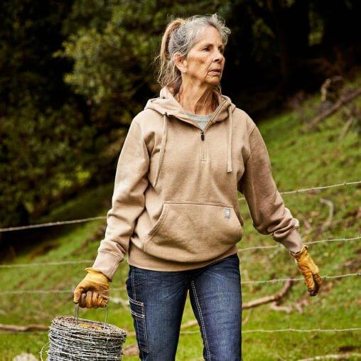 woman holding wire in ariat hoodie