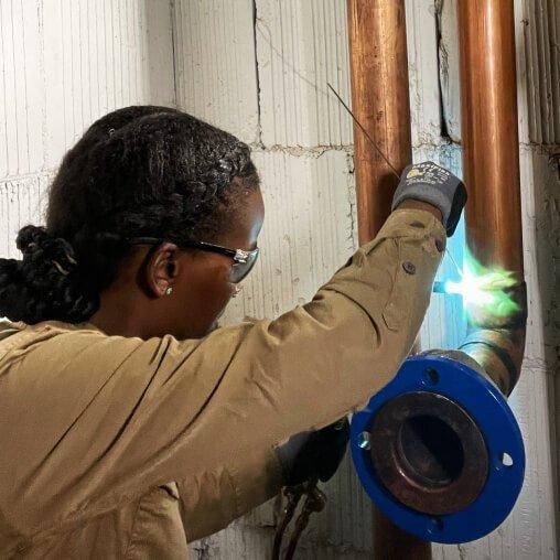 woman welding pipe