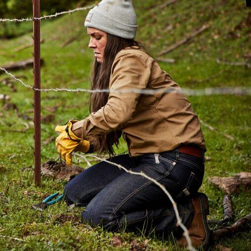 woman working with barbwire fence