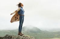 Woman standing on mountain in Ariat outfit