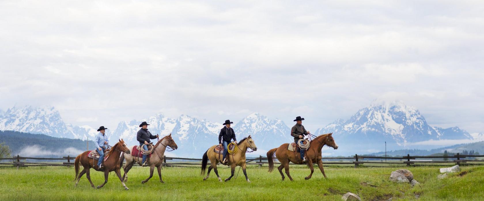 four men riding horses