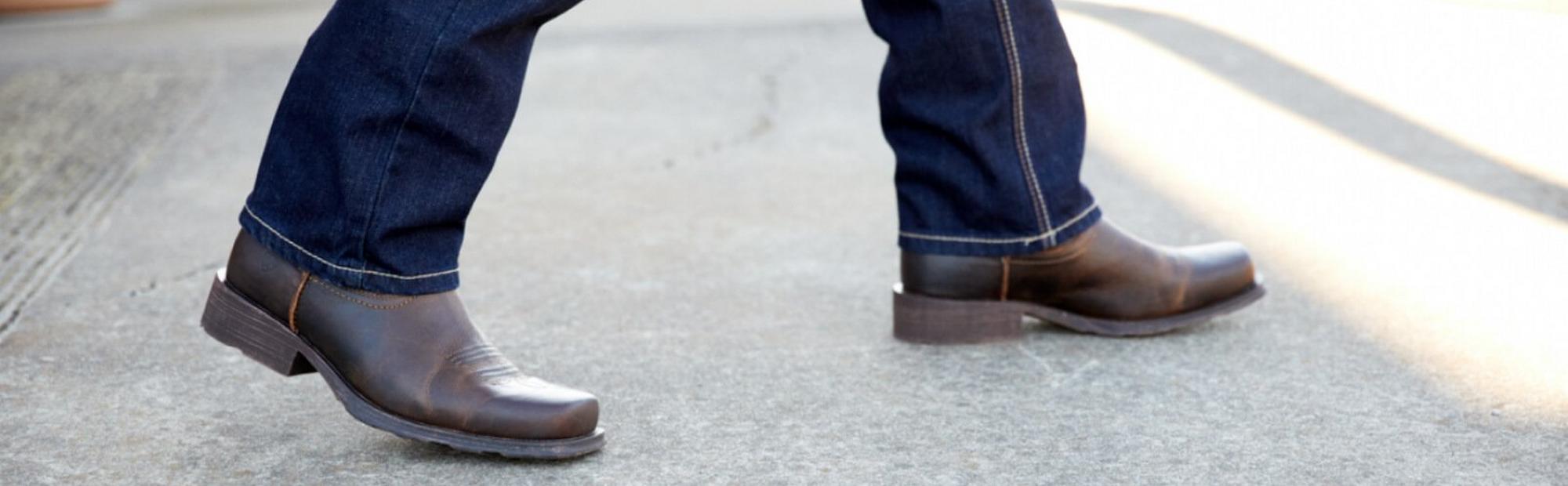 Why do guys wear cowboy boots outside of their jeans? It looks so