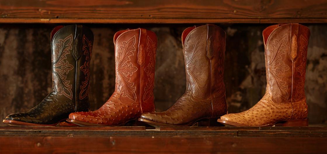 Ariat Western bench made boots lined up on a window sill