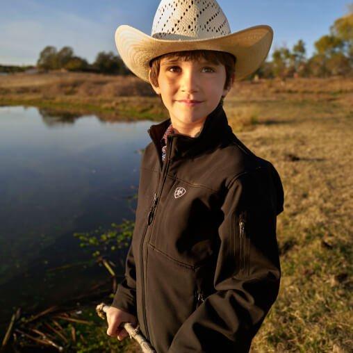 boy in Ariat jacket and cowboy hat