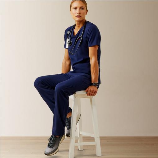 women sitting on still in medical scrubs
