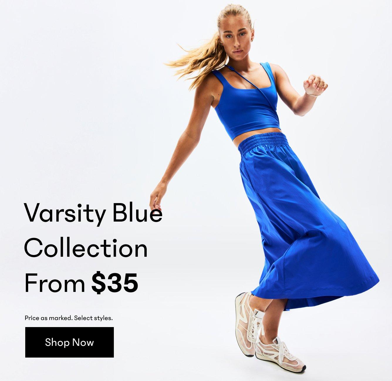 a woman in a blue dress is running with a ball