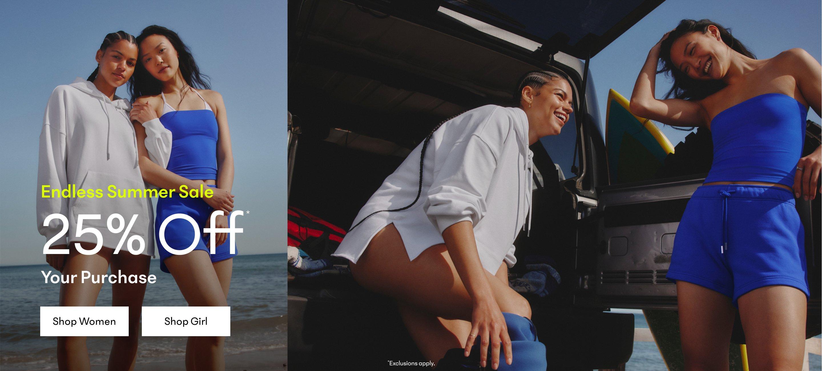 two women in blue shorts and tank tops sitting in the back of a van