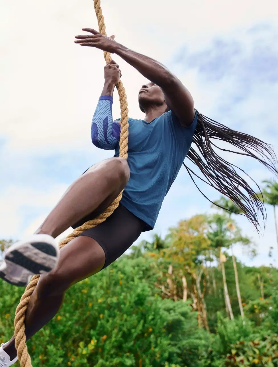 Woman climbing a rope