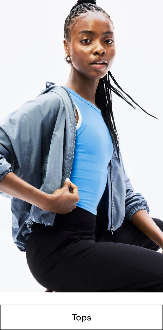 a woman in a blue top posing for a picture