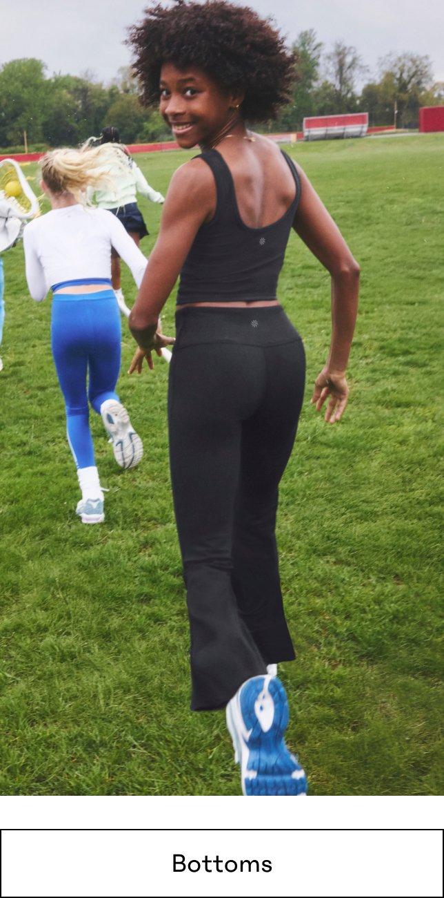 a group of women are running in a field with a ball