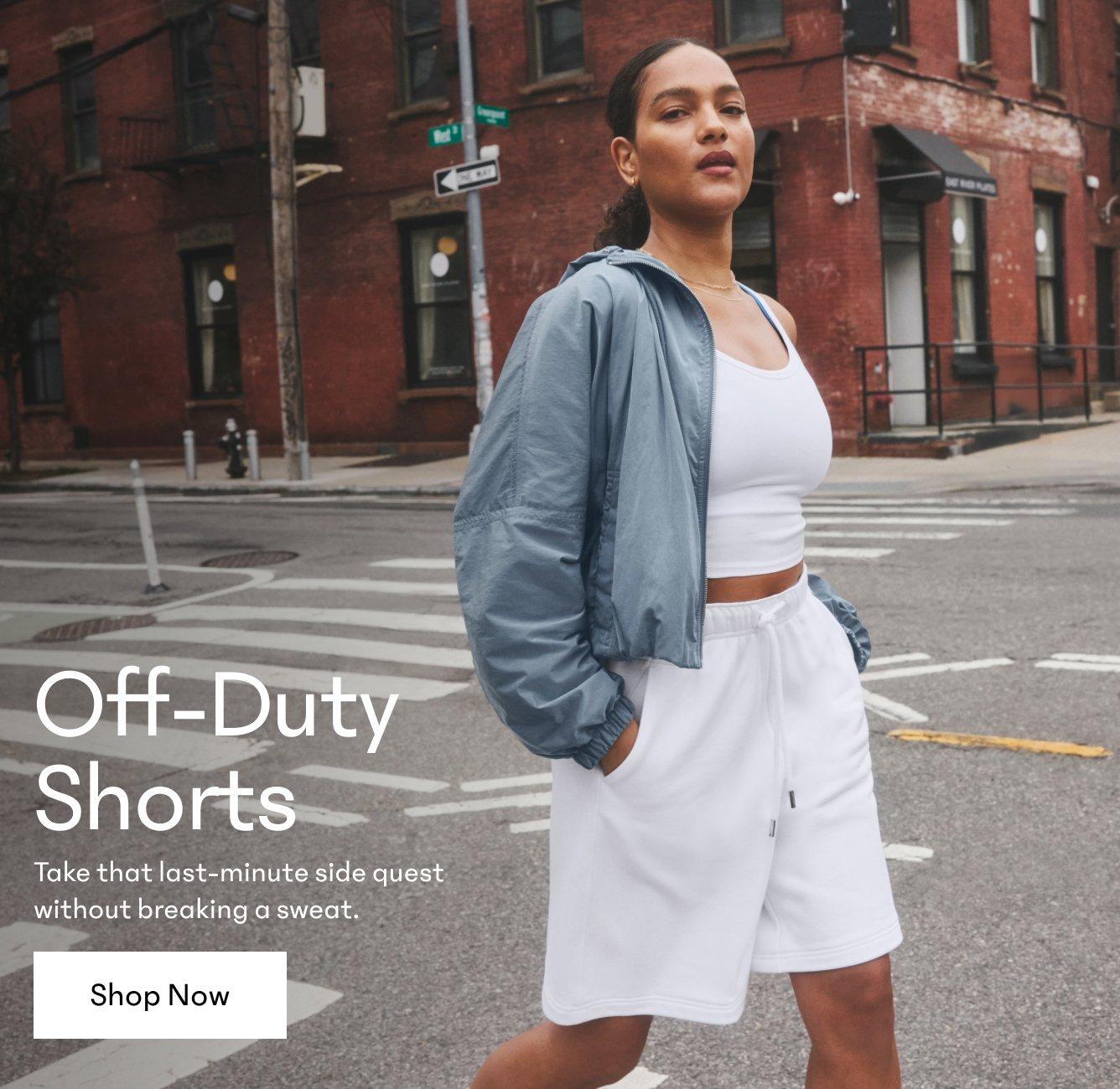 Off-Duty Shorts. Take that last-minute side quest without breaking a sweat. Shop Now. a woman in a grey jacket and white top and shorts crossing the street