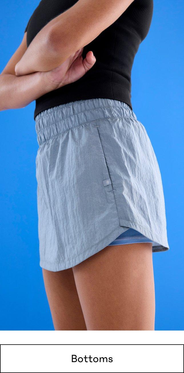 Girl Bottoms. a girl in shorts and a tank top with her arms crossed