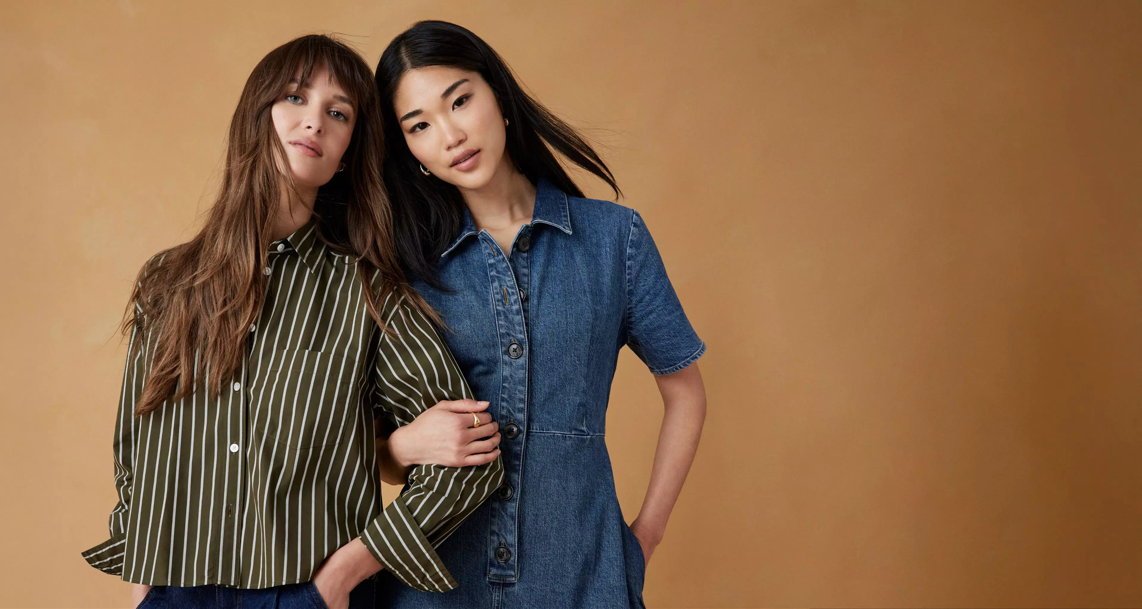 Woman in striped brow shirt. Woman in denim dress.