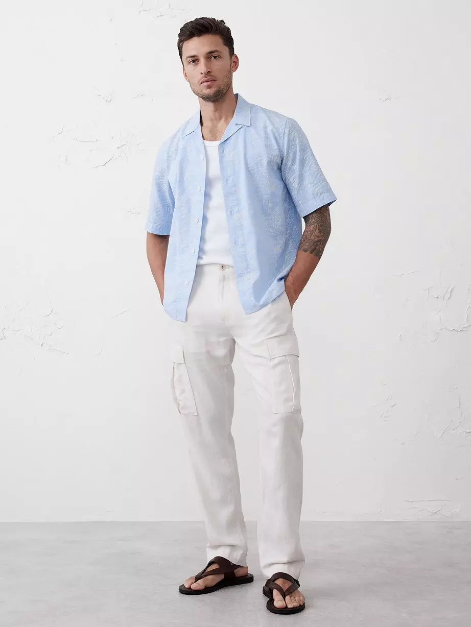 Man in blue shirt with tan pants.
