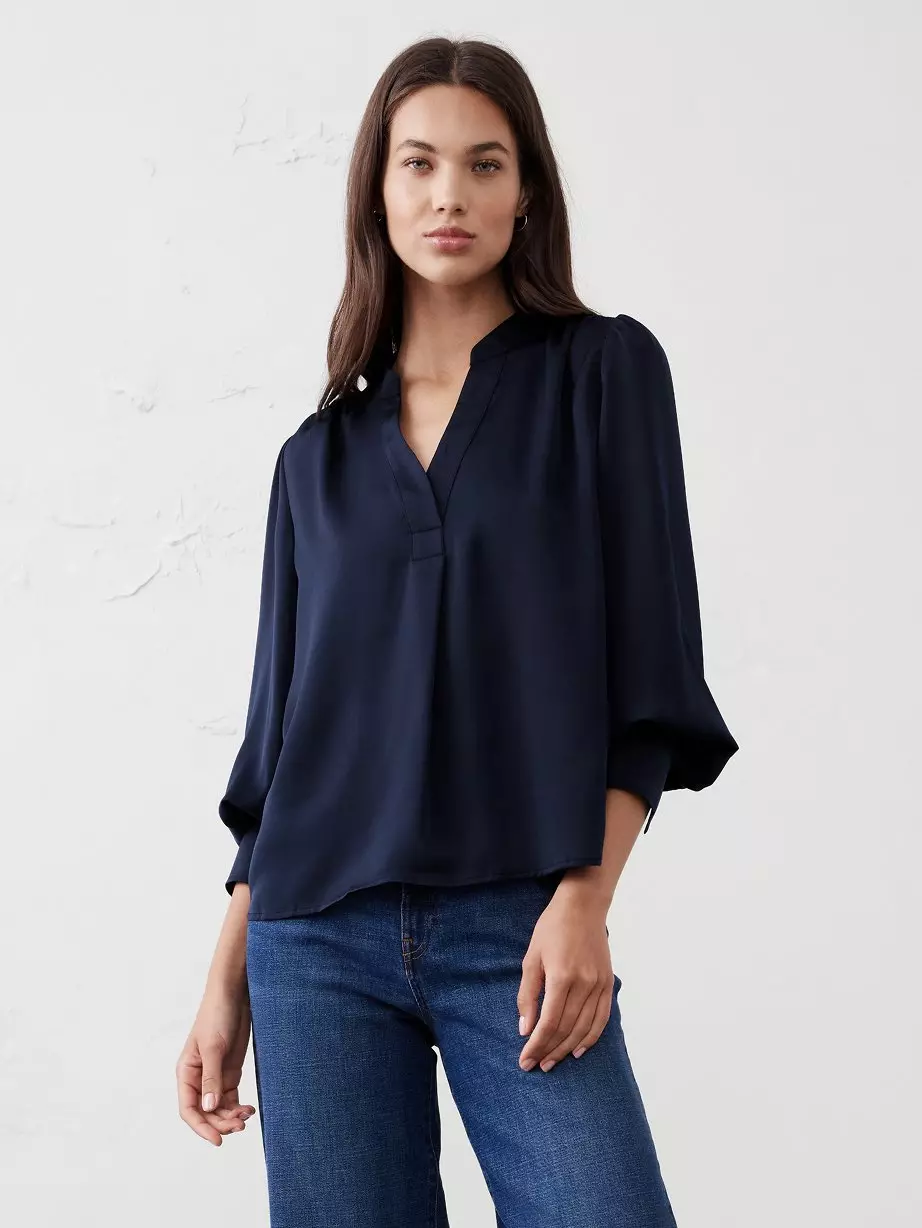 Woman in navy top and jeans.