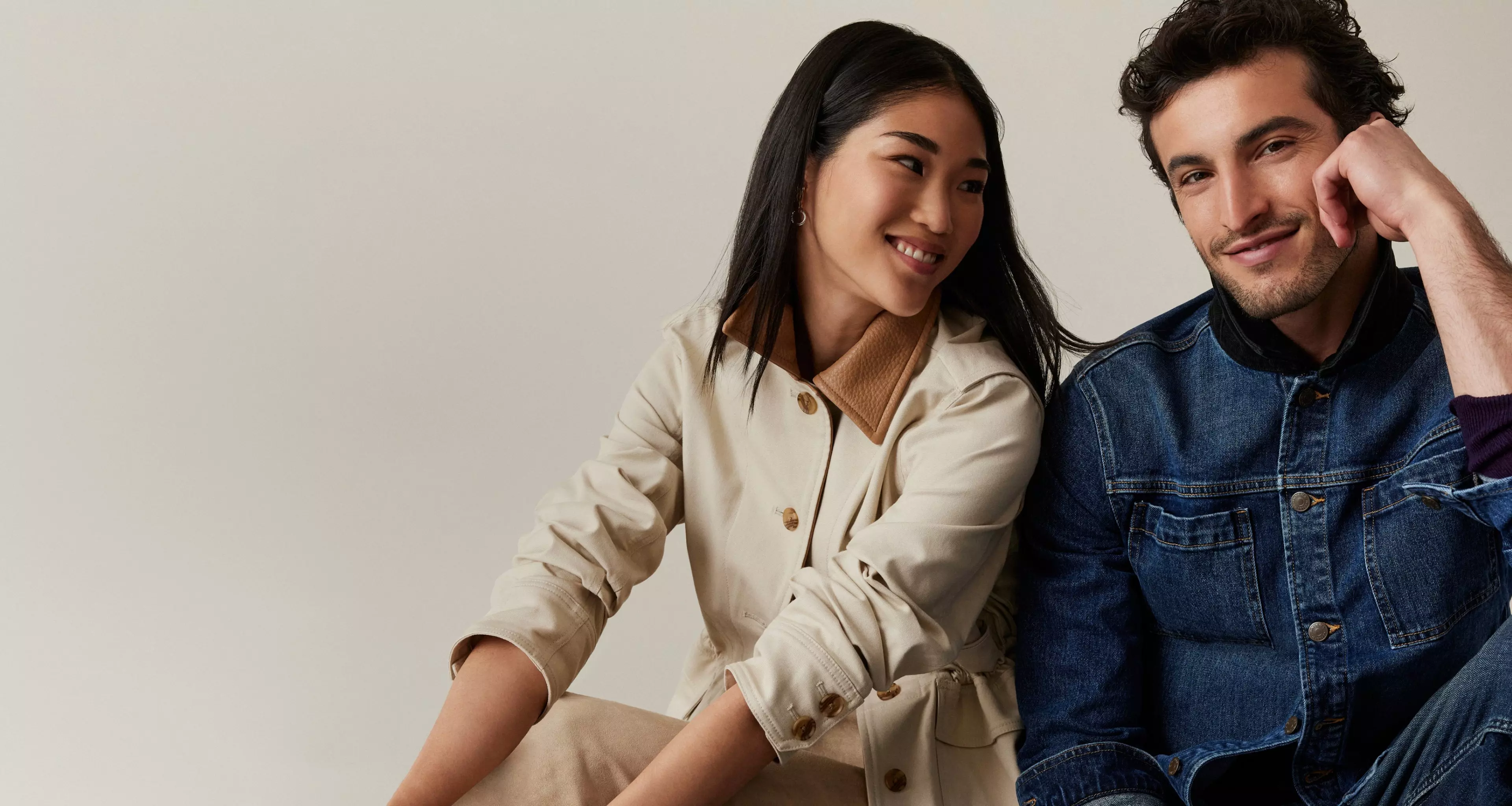 Woman in beige jacket. Man in denim jacket.